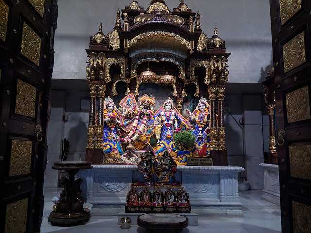 Intricately decorated idols of Lord Ram, Sita, Lakshman, and Hanuman inside the sanctum of ISKCON Temple Ujjain, showcasing vibrant traditional attire and ornate temple architecture.