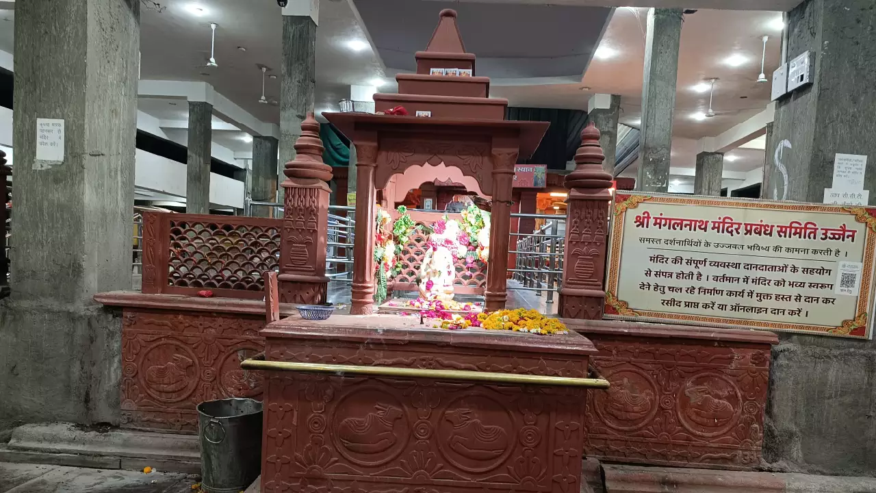 Inner sanctum of Mangalnath Temple in Ujjain featuring the sacred idol, red sandstone architecture, and devotional offerings, a popular site for Mangal dosh remedies and astrology worship.