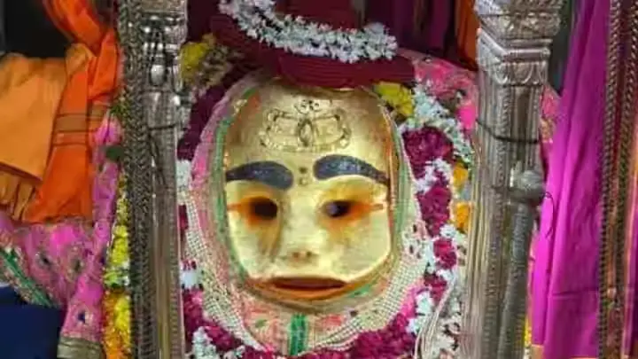 Decorated idol of Kal Bhairav adorned with a golden mask and floral garlands at Kal Bhairav Temple in Ujjain, Madhya Pradesh